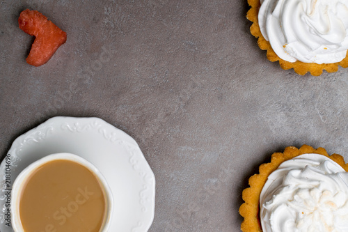 Delicious Dessert. Lemon tartlet tart with meringue and cup of hot coffee, watermelon heart on grey stone concrete table background. photo