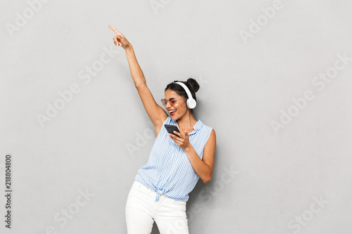 Portrait of a cheerful young woman in sunglasses