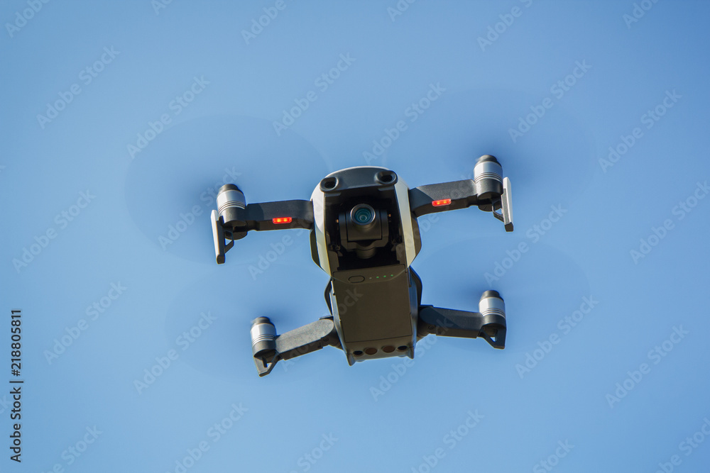 Drone with propellers flies in sky and photographs