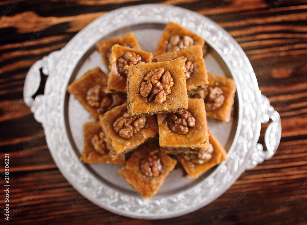 appetizing baklava with nuts and honey closeup on a wooden background appetizing baklava with nuts and honey closeup on a wooden background