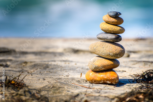 Stacked stones naturally balanced on a sunny day by the beach. Rock Balancing.