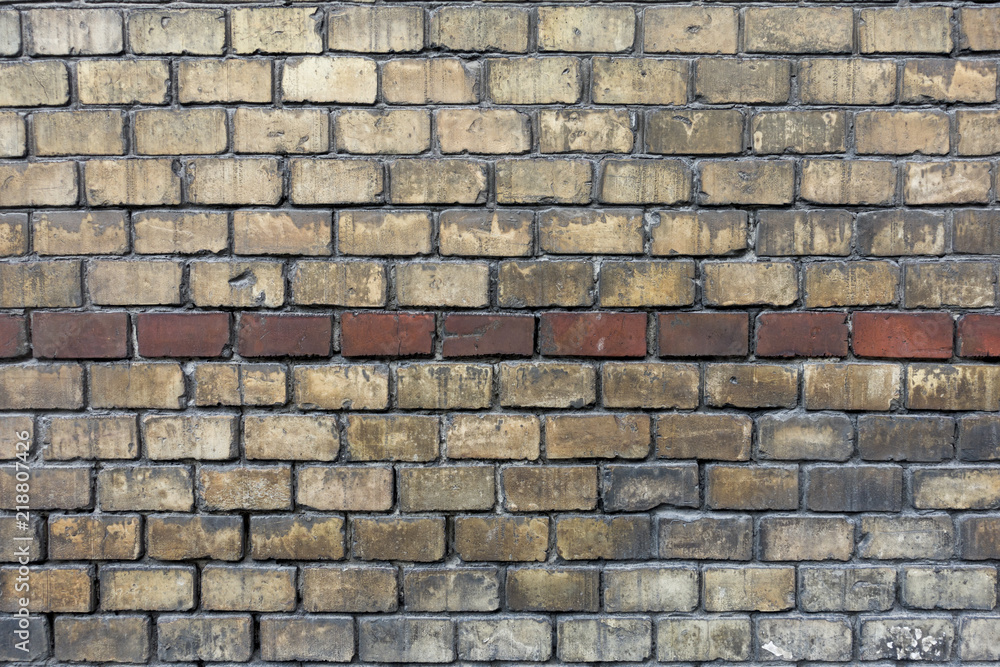 Obraz premium Brick wall with bicolor yellow and brown bricks