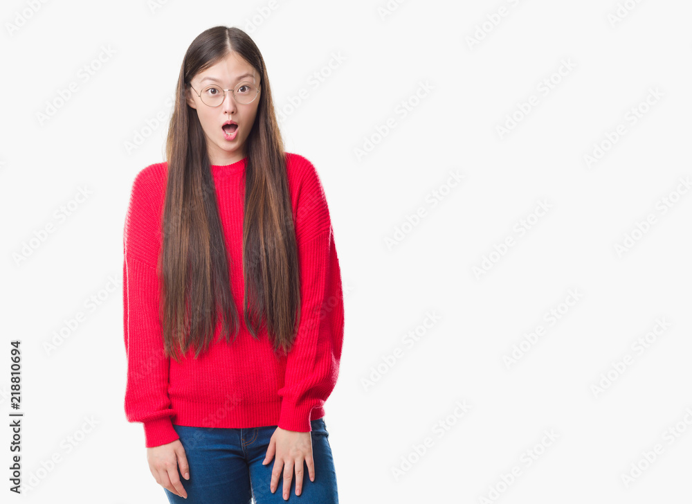 Young Chinese woman over isolated background wearing glasses afraid and shocked with surprise expression, fear and excited face. Young Chinese woman over isolated background wearing glasses afraid and shocked with surprise expression, fear and excited face.