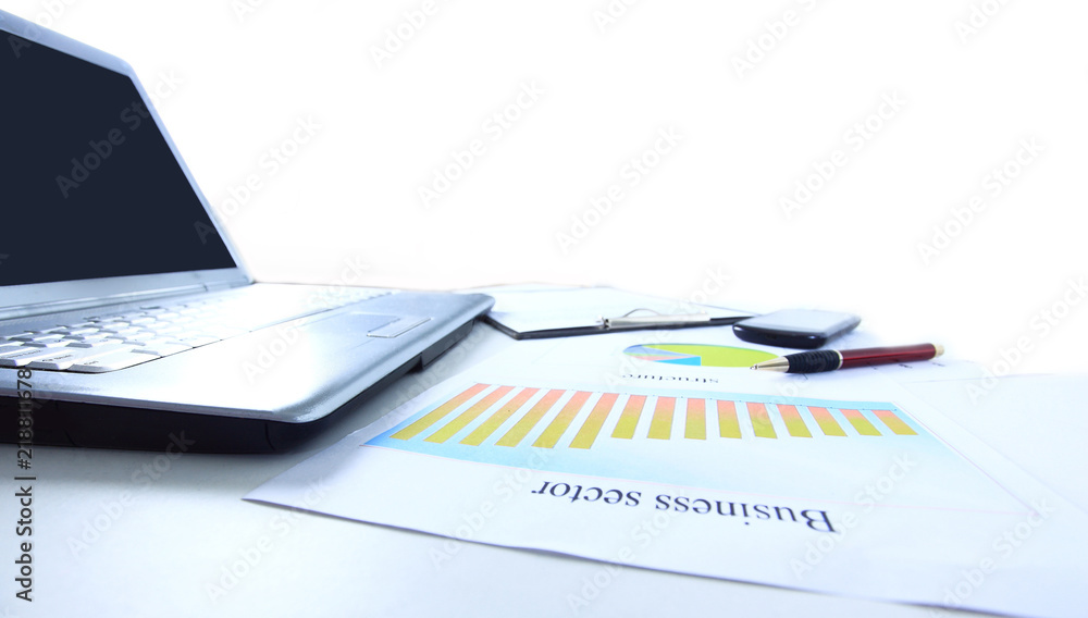 laptop and a marketing scheme on the table from a businessman laptop and a marketing scheme on the table from a businessman