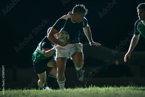 Flanker with ball tackling during game © Jacob Lund