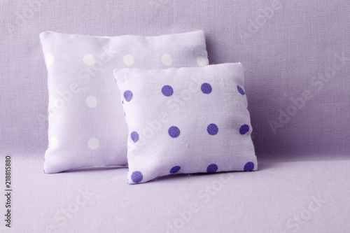 Spotted pillows on purple background