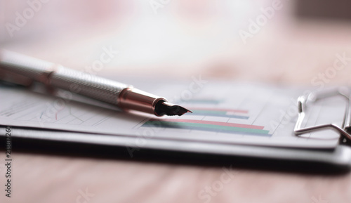 close up. pen and financial chart on the table.business backgrou