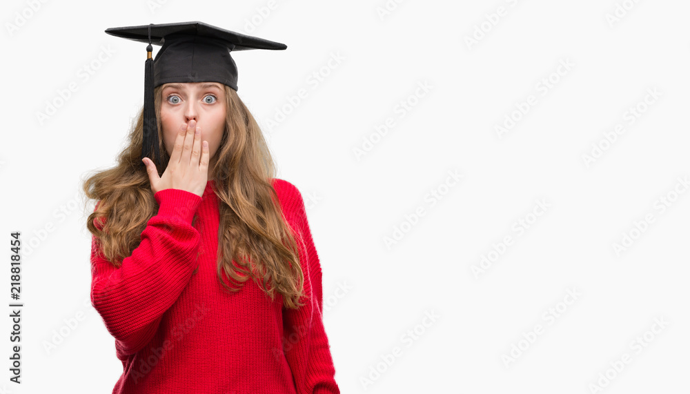 Young blonde woman wearing graduation cap cover mouth with hand shocked with shame for mistake, expression of fear, scared in silence, secret concept Young blonde woman wearing graduation cap cover mouth with hand shocked with shame for mistake, expression of fear, scared in silence, secret concept