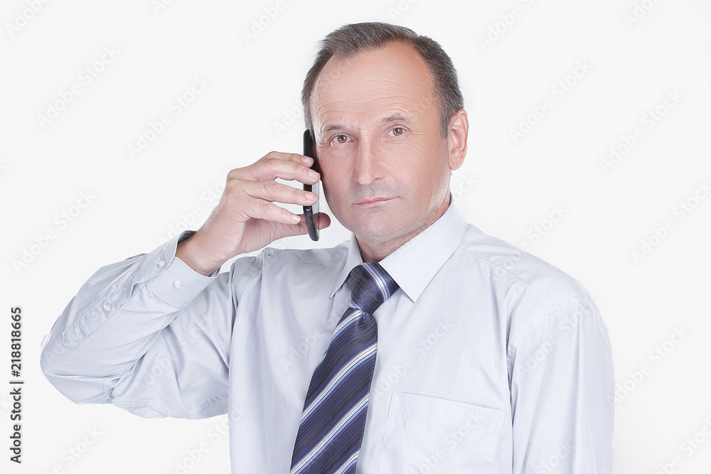 serious businessman talking on a mobile phone serious businessman talking on a mobile phone
