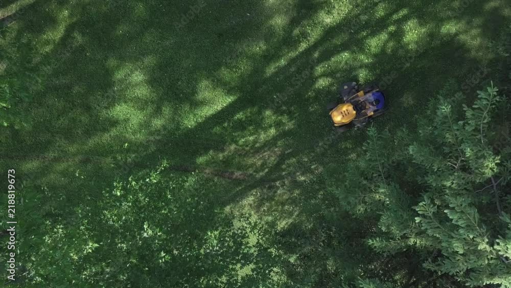 drone rises up over lawnmower as it drives underneath. drone rises up over lawnmower as it drives underneath.