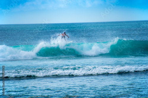Single surfer on a wave