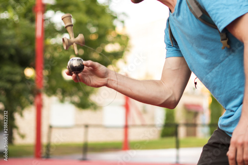 kendama tricks in the street a balance wooden piece