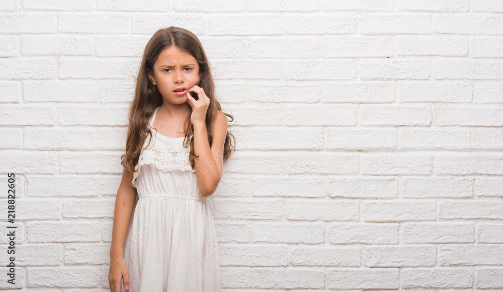 Young hispanic kid over white brick wall touching mouth with hand with painful expression because of toothache or dental illness on teeth. Dentist concept. Young hispanic kid over white brick wall touching mouth with hand with painful expression because of toothache or dental illness on teeth. Dentist concept.