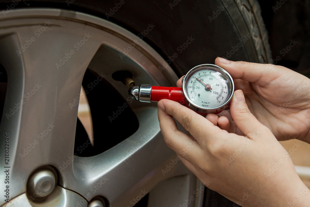 Tire pressure gauge : Hand holding pressure gauge checking air pressure ...