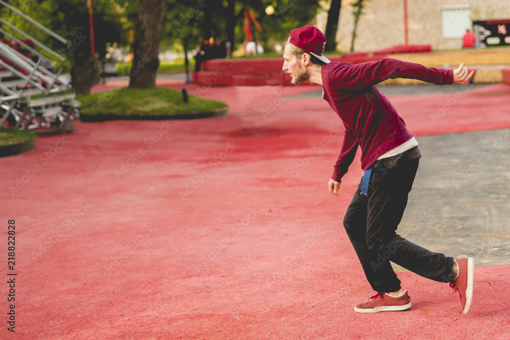 young man tracer in causual doing parkour in city on a summer day