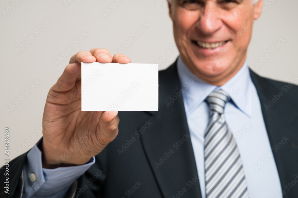 Businessman showing a business card Businessman showing a business card