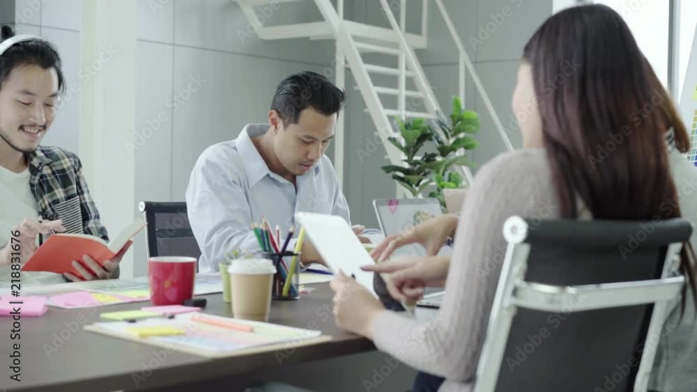 Group of casually dressed business people discussing ideas in the office. Creative professionals gathered at the meeting table for discuss the important issues of the new successful startup project. Group of casually dressed business people discussing ideas in the office. Creative professionals gathered at the meeting table for discuss the important issues of the new successful startup project.