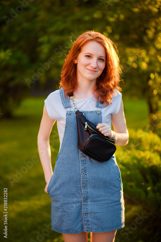Red-haired girl with waist bag