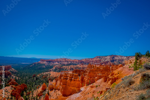 Bryce Canyon National Park landscape, Utah, United States. Nature scene showing beautiful hoodoos, pinnacles and spires rock formations. including Thors Hammer, in a gorgeous blue sky