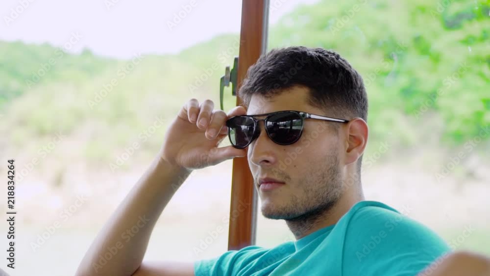 Cool, Attractive man on boat looking away from camera, makes eye contact seductively with woman. Cool, Attractive man on boat looking away from camera, makes eye contact seductively with woman.