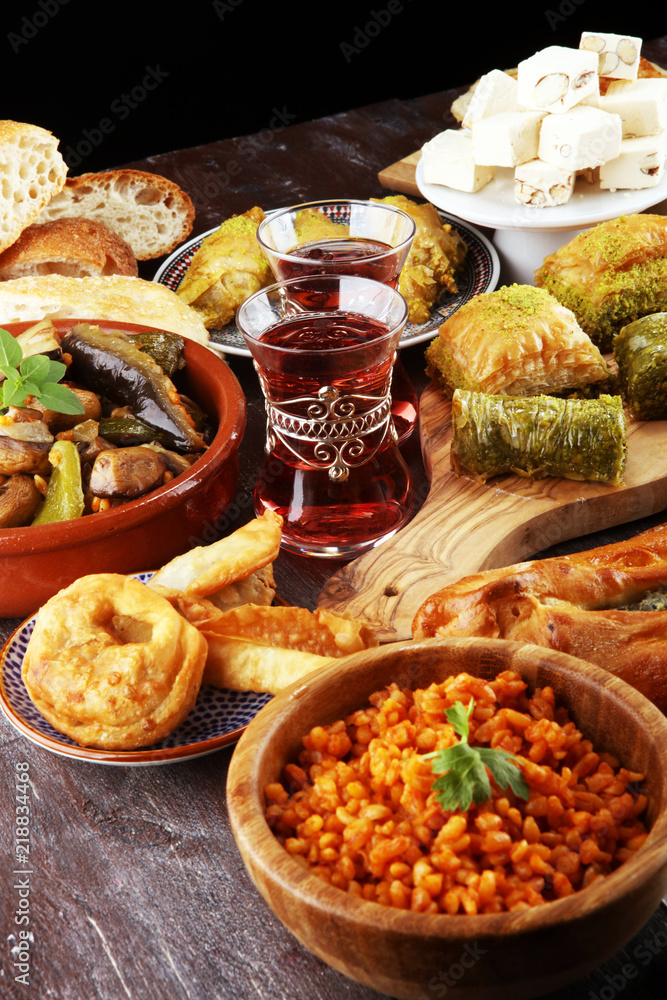 Obraz premium Middle eastern or arabic dishes and assorted meze, concrete rustic background. sambusak. Turkish Dessert Baklava with pistachio. Sarma. Halal food. Lebanese