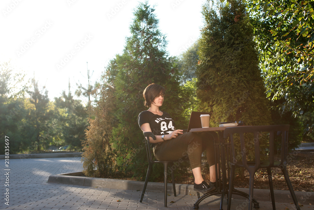 Young woman working at a table outdoors Young woman working at a table outdoors