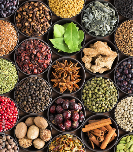 Fototapeta Naklejka Na Ścianę i Meble -  bright  spices and herbs in cups, top view. background for packing with European condiments.