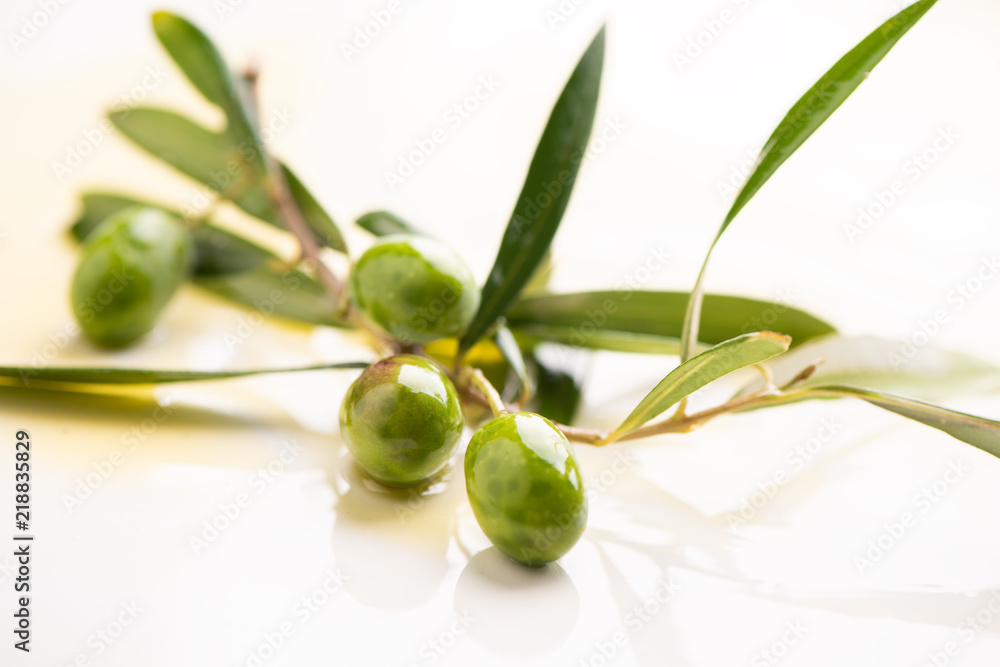 Three olives and olive oils with leaves