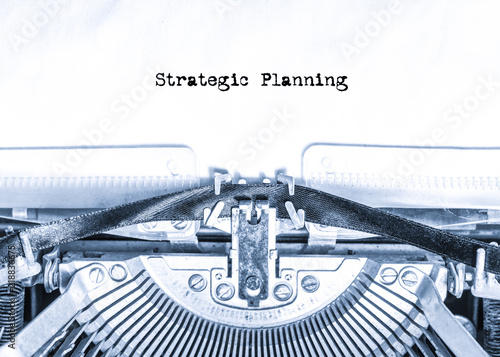 retro vintage typewriter with a sheet of paper with printed text Strategic Planning. writer. business finance.