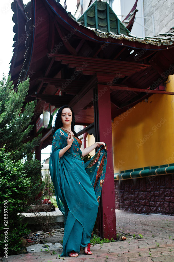 Portrait of beautiful indian brumette girl or hindu woman model against japanese traditional house.