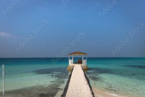 A small hut gazebo surrounded by tropical beach in Maldives. © LMspencer