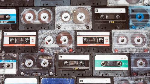 Vintage audio cassette on a wooden background. Collection of various retro audio tapes 