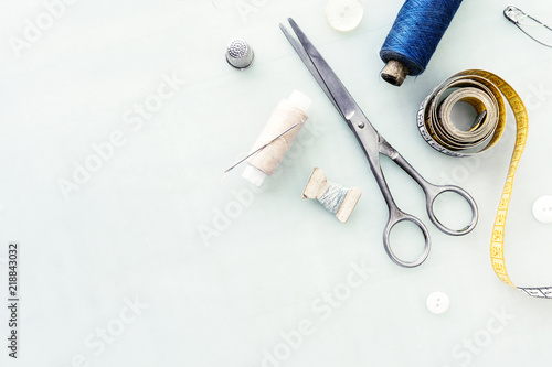 фотографія Set of tailoring tools and accessories on table, top view