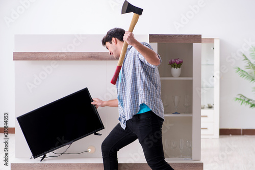 Man trying to fix broken tv photo