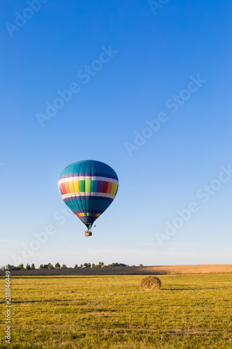 Colorful hot-air balloon flying over the forest