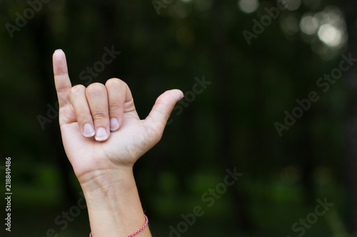 signs and symbols for people with disabilities mute and deaf humans concept of dactyl alphabet by female hand and fingers with empty space for copy or text on unfocused dark background © Артём Князь