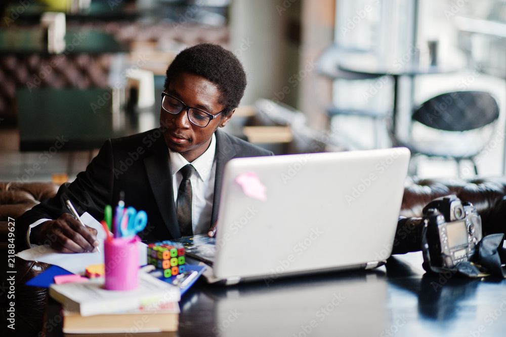 African man sitting behind laptop African man sitting behind laptop