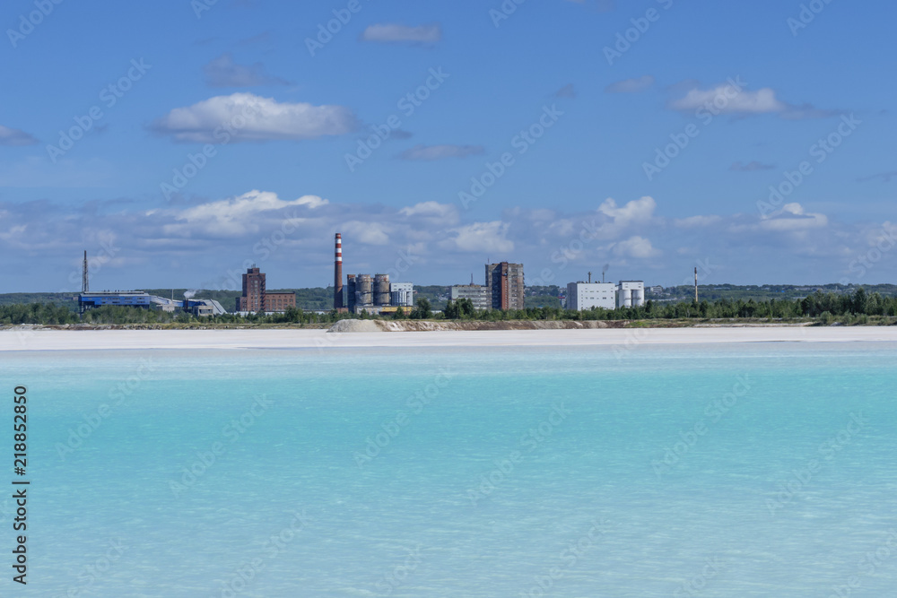 industrial tailing pond with beautiful blue water on the background of the factory landscape