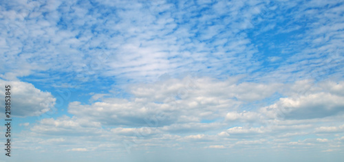 Light clouds in the blue sky. Wide photo.