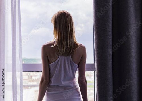 sad lady stay by the window  © kristinav85