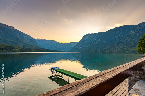 Sunset above Bohinj lake, Slovenia national park. Dramatic and magical colors, mystic water, mountains and Alps in background.