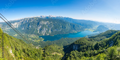 Aerial view of Bohinj lake from Vogel cable car station. Mountains of Slovenia in Triglav national park. Julian alps landscape. Blue water, summer sky, mountains in the bakcground