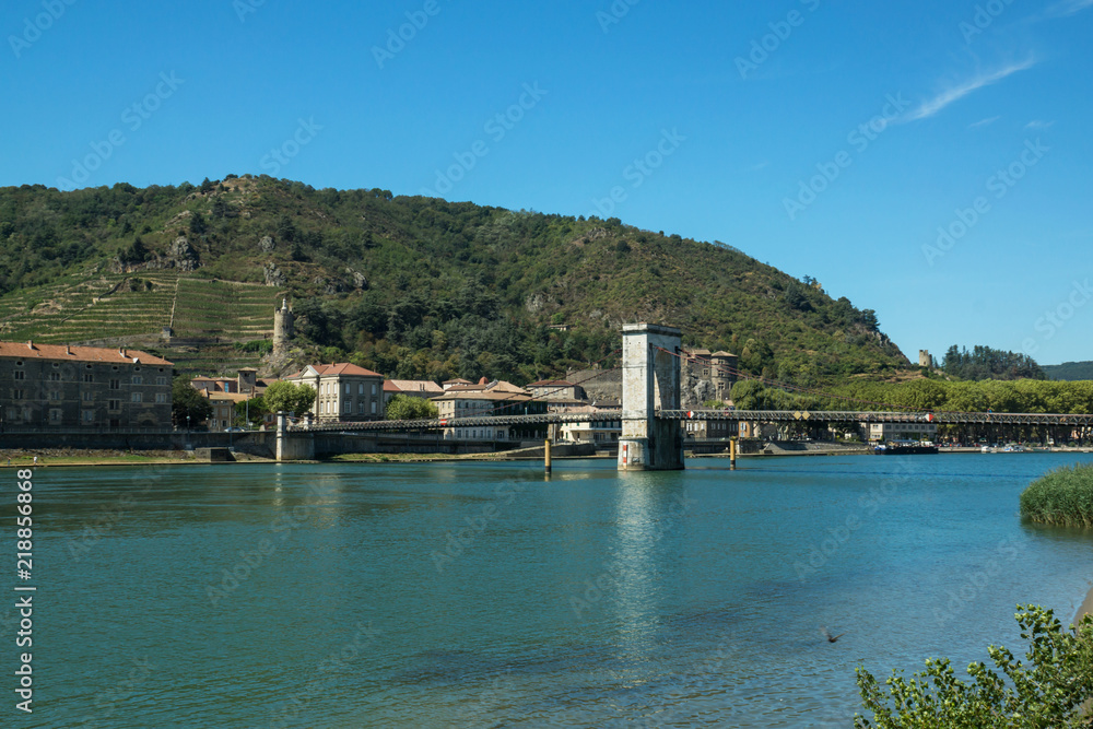 Pedestrian Bridge in Tournon town in french vineyard region with Rhone river in a foreground.