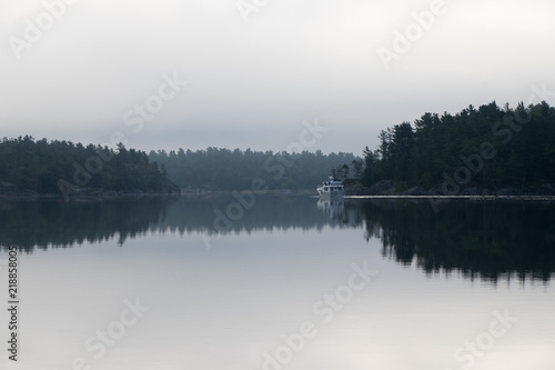 boat leaving on a calm summer morning