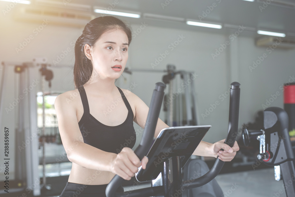 Fototapeta premium Fitness woman health exercise at gym. Healthy workout concepts.