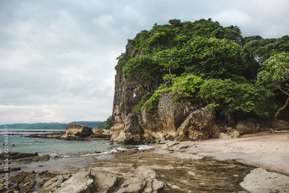 The rocky beach shore of Playa Cuevas in between Santa Teresa and Malpaís on the Nicoya peninsula of Costa Rica The rocky beach shore of Playa Cuevas in between Santa Teresa and Malpaís on the Nicoya peninsula of Costa Rica