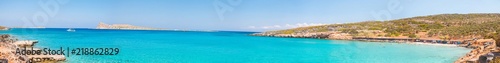 Fototapeta Naklejka Na Ścianę i Meble -  Beautiful bay with turquoise water. A popular tourist beach. Kolokitha beach. Peninsula Kalydon. Crete, Elounda,Greece.Panoramic view HD.