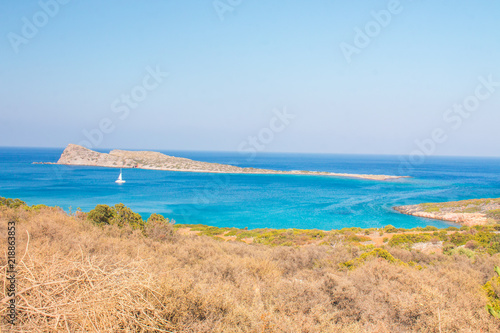 Beautiful beach of Crete with turquoise water. A popular tourist beach. Kolokitha beach. Peninsula Kalydon. Crete, Elounda,Greece.