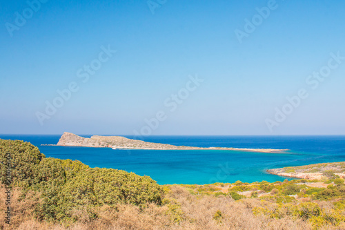 Beautiful beach of Crete with turquoise water. A popular tourist beach. Kolokitha beach. Peninsula Kalydon. Crete, Elounda,Greece.