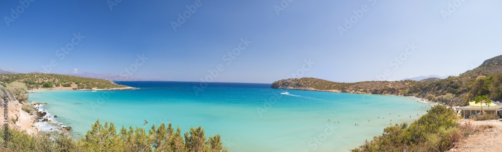 Beautiful colorful beach at Crete island, Greece. Voulisma paradise beach with rocks and mountains.  Summer vacation travel holiday background concept.